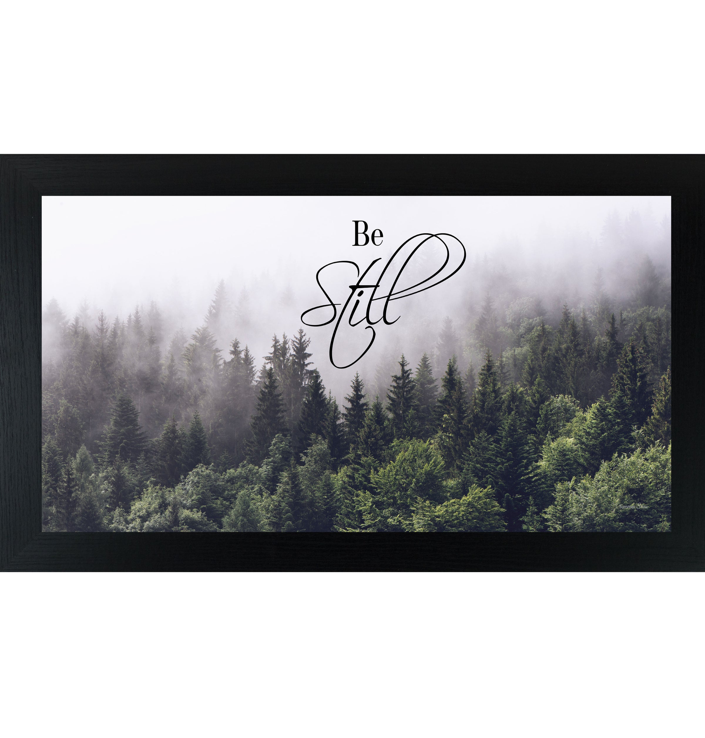Framed inspirational wall art featuring a misty forest landscape with soft light and the words Be Still centered in calm, minimalist typography