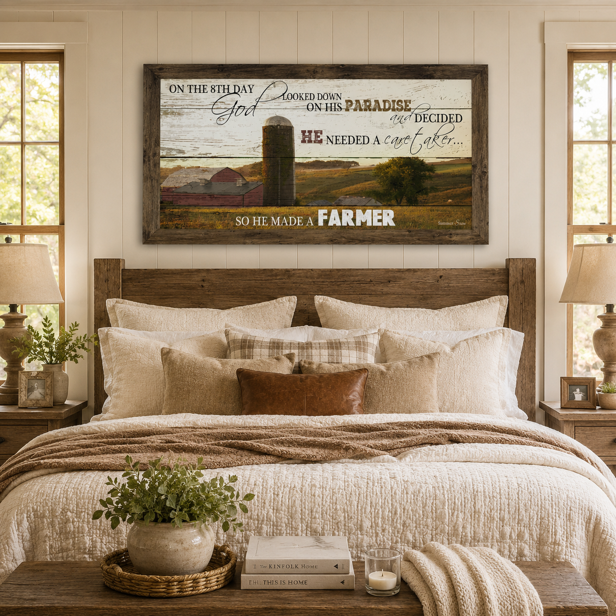 Natural brown framed wide panoramic farmhouse wall art featuring the full On The 8th Day God Made A Farmer quote with red barn and silo displayed as a large 40x20 statement piece above a reclaimed wood headboard in a cozy farmhouse master bedroom with white quilt and plaid pillows