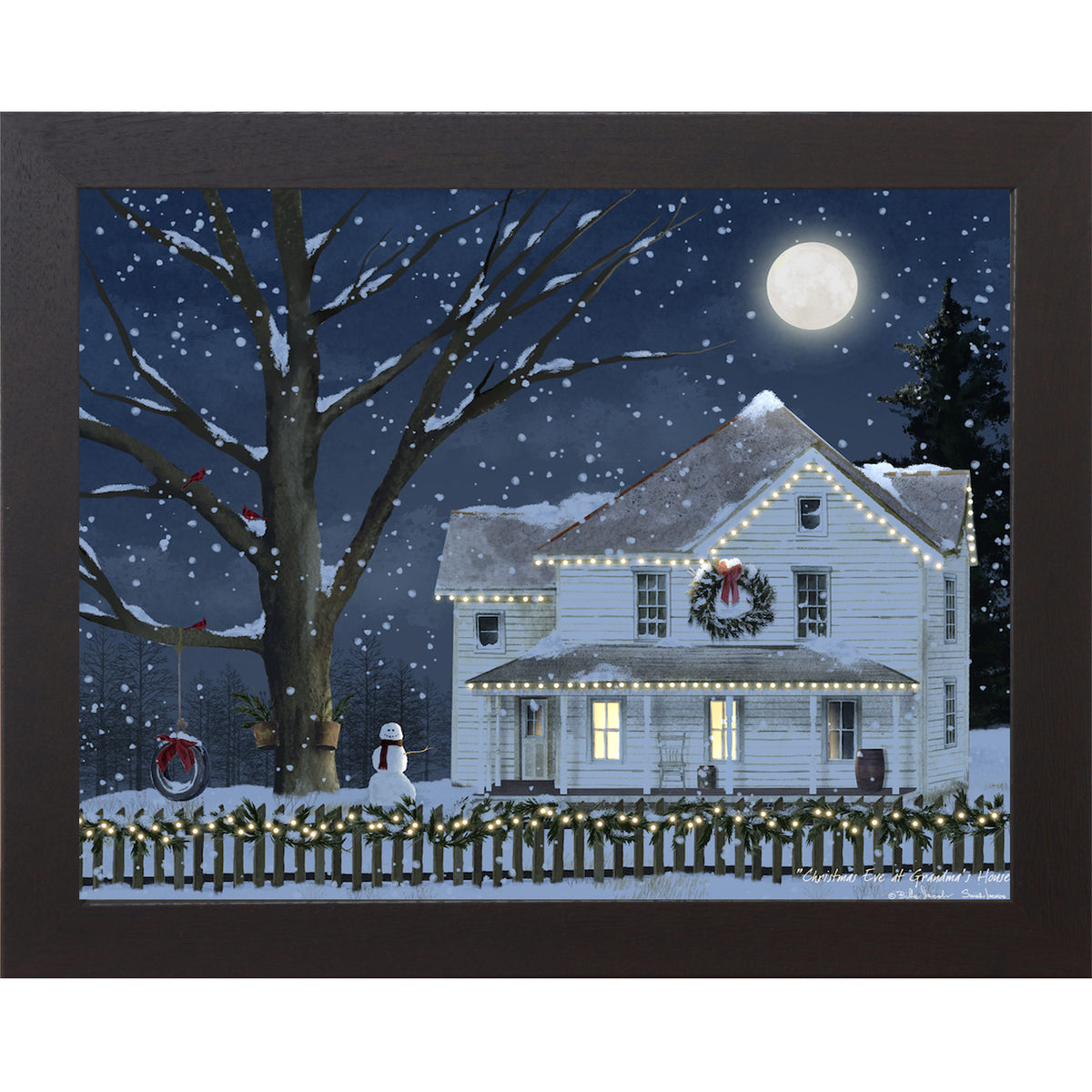 Black framed Billy Jacobs Christmas Eve at Grandma's House wall art featuring a glowing white farmhouse with string lights wreath and snowman under a full moon in a midnight blue snowy sky with cardinals in a bare tree