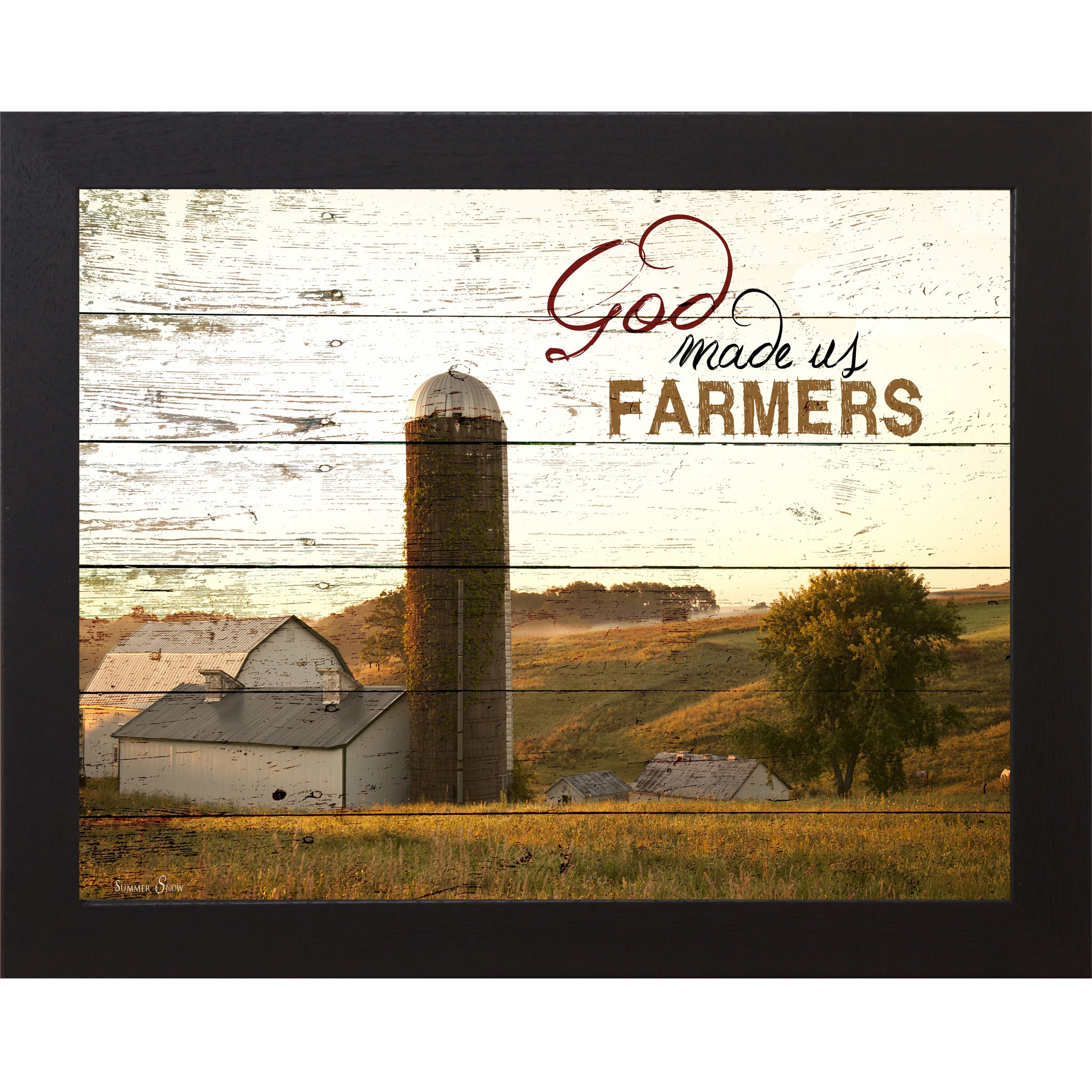 Black framed horizontal farmhouse landscape wall art featuring a white barn and silo on rolling green hills with pallet wood background and the words God Made Us Farmers