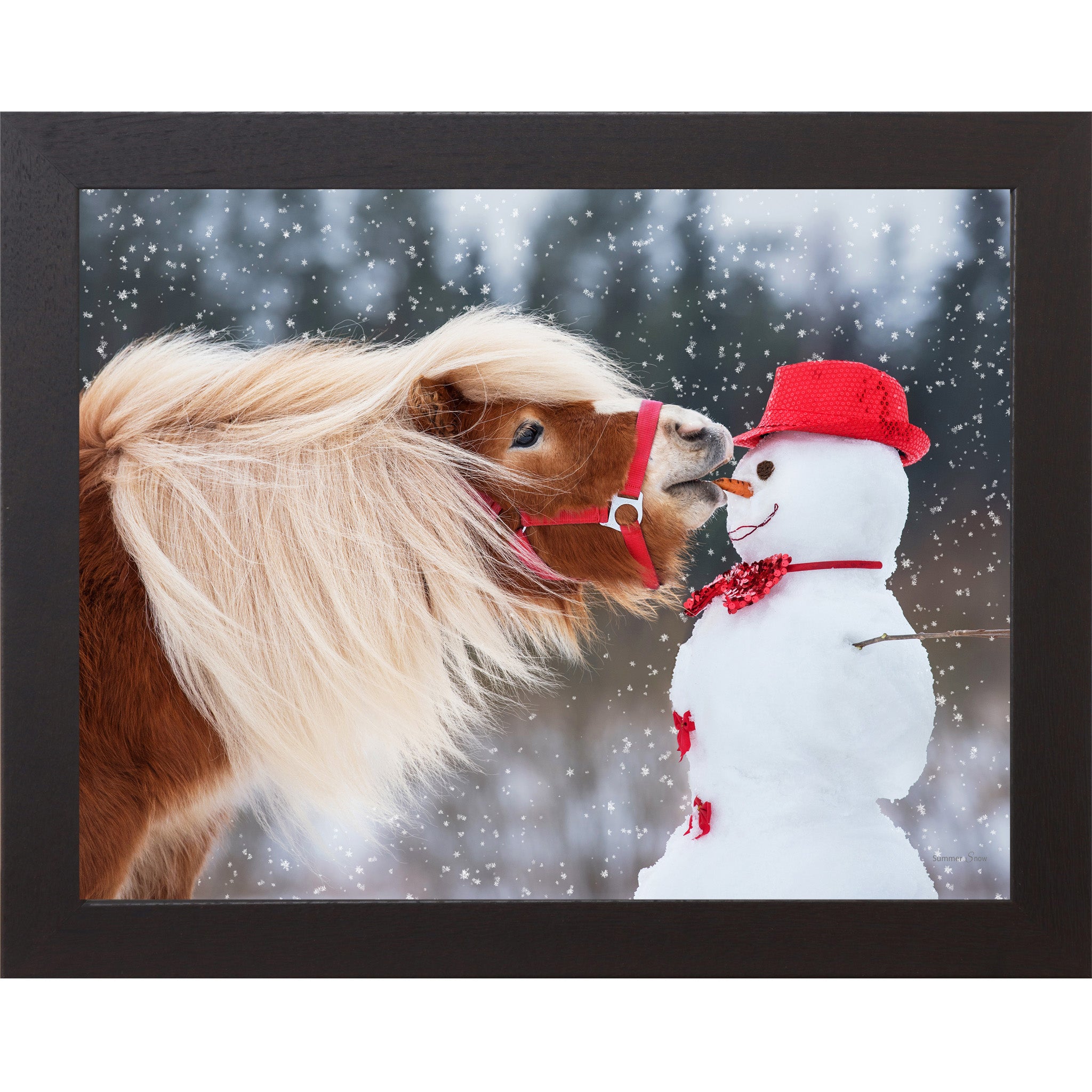 Black framed landscape equine wall art featuring a chestnut Haflinger pony with flowing blonde mane stealing a carrot from a red-hatted snowman in falling snow — Can't Resist SN338