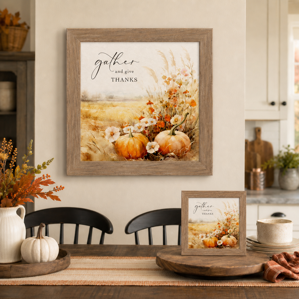 Farmtable framed Gather and Give Thanks square fall wall art SN172 displayed large on farmhouse dining room wall above black chairs and wood table with 8x8 easel back on table beside white pumpkin dough bowl and fall berry branches — watercolor pumpkins wildflowers pampas grass and golden wheat field harvest scene