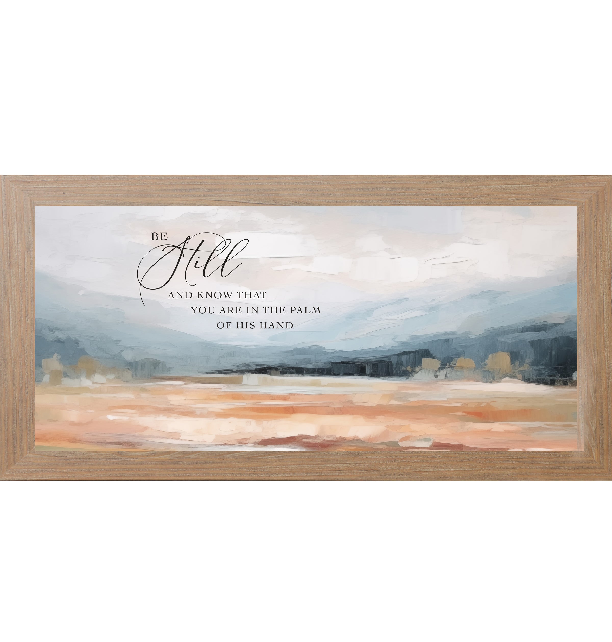 Farmtable framed wide landscape Christian wall art with Be Still And Know That You Are In The Palm Of His Hand scripture in oversized script over dramatic blue-grey mountains and soft peach blush terracotta field