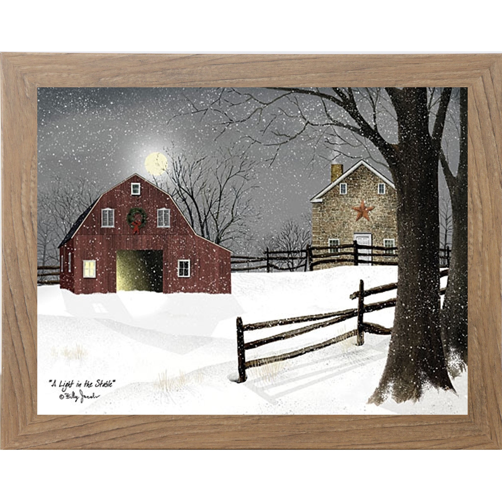 Farmtable framed landscape Billy Jacobs wall art print of a red barn with a Christmas wreath and glowing door on a moonlit snowy night with a stone farmhouse and split rail fence titled "A Light in the Stable"