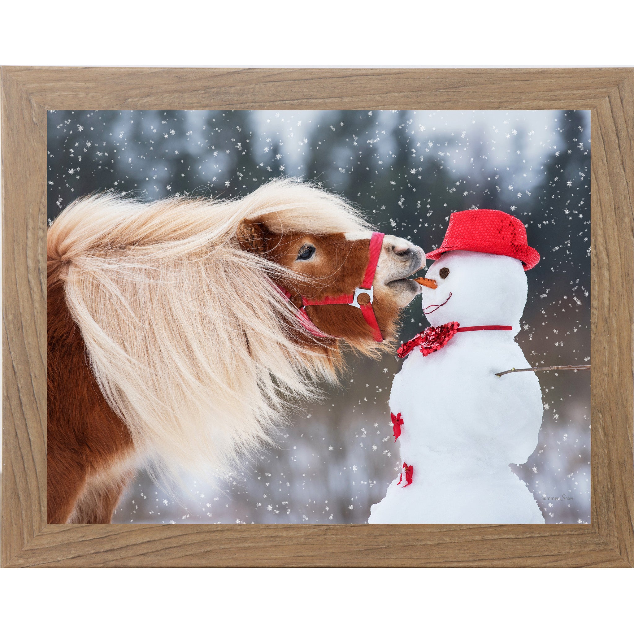 Farmtable framed landscape equine wall art featuring a chestnut Haflinger pony with flowing blonde mane stealing a carrot from a red-hatted snowman in falling snow — Can't Resist SN338