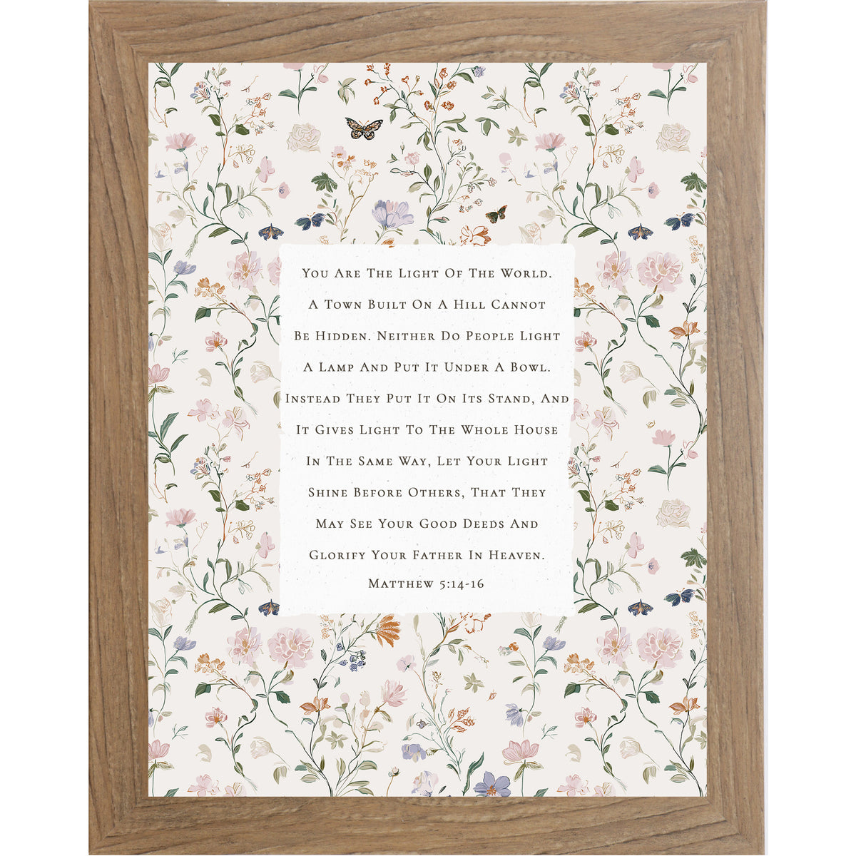 Vertical framed wall art featuring Matthew 5:14-16 Bible verse centered on a neutral background surrounded by soft pastel florals and butterflies, Christian scripture decor in 8x10 and larger sizes.