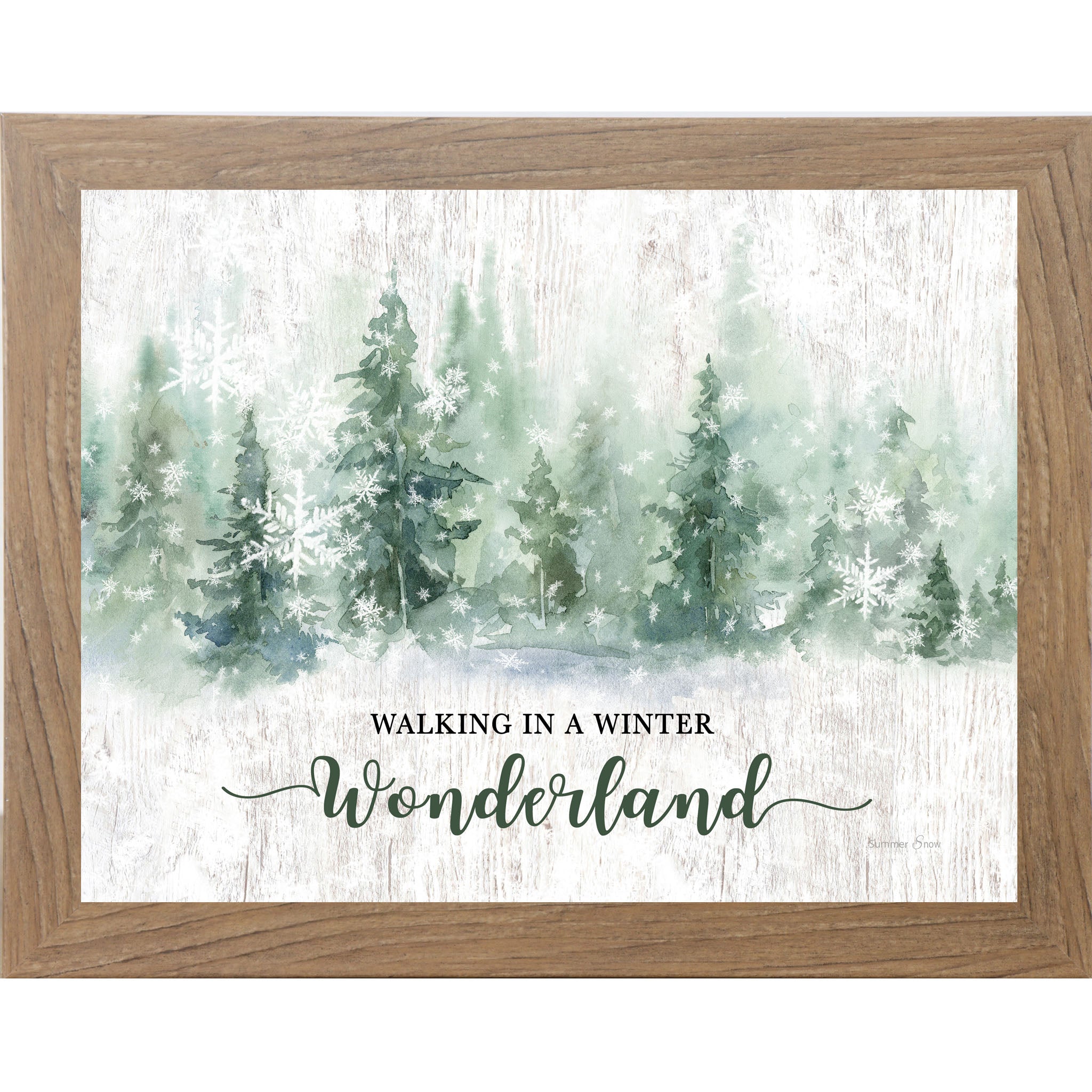 Farmtable framed landscape watercolor winter wall art featuring snowy green pine trees and falling snowflakes with the words "Walking In A Winter Wonderland"
