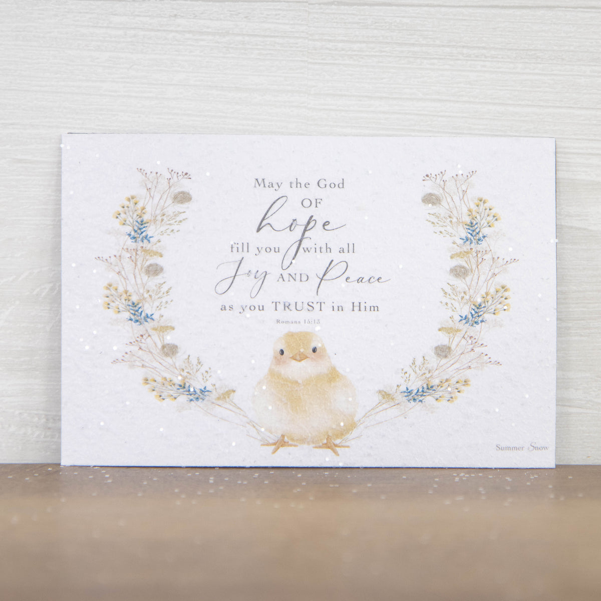 Christian scripture magnet featuring Romans 15:13 with a baby chick and soft floral wreath, spring faith encouragement decor with subtle glitter finish