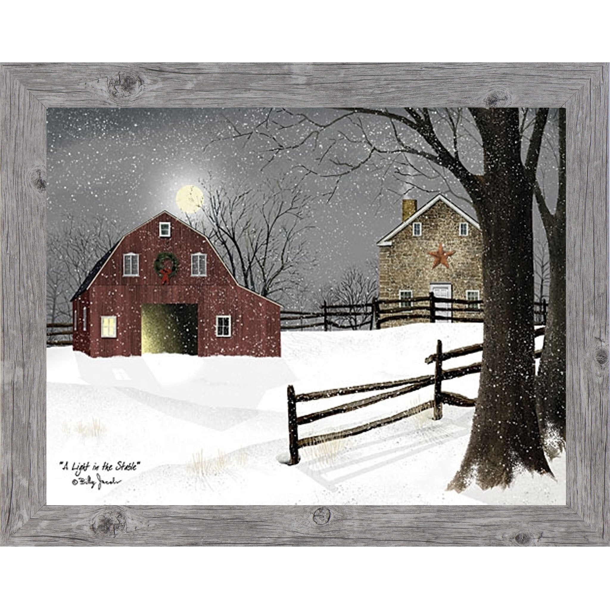 Gray framed landscape Billy Jacobs wall art print of a red barn with a Christmas wreath and glowing door on a moonlit snowy night with a stone farmhouse and split rail fence titled "A Light in the Stable"