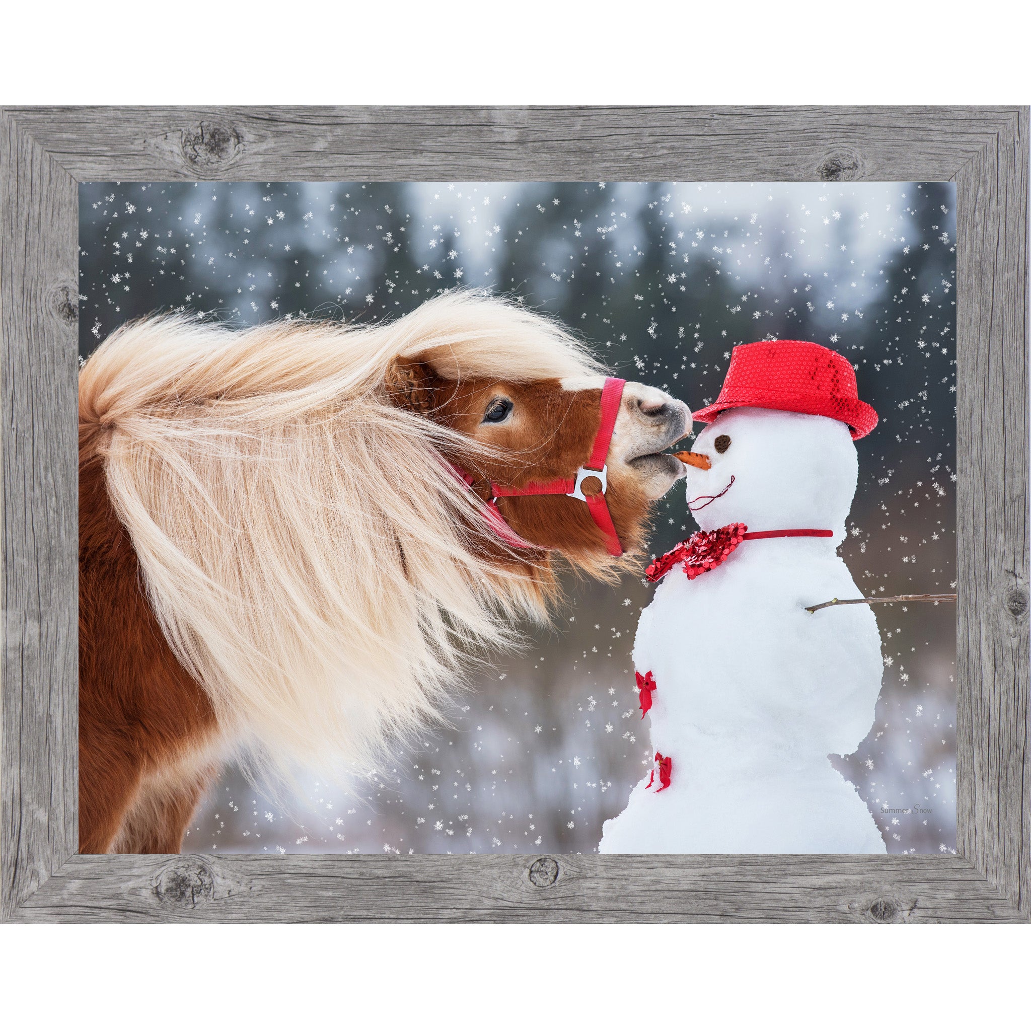 Gray framed landscape equine wall art featuring a chestnut Haflinger pony with flowing blonde mane stealing a carrot from a red-hatted snowman in falling snow — Can't Resist SN338