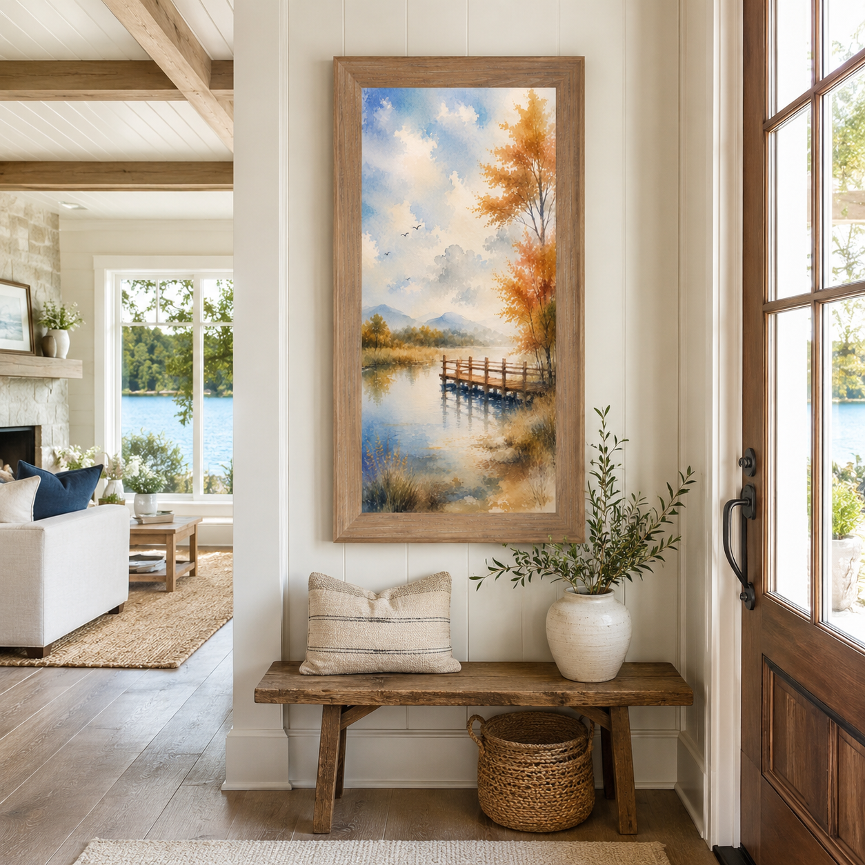 Farmtable framed tall portrait watercolor autumn pier wall art displayed as a large 20x40 statement piece in a bright lake house entryway above a rustic wood bench with actual lake views visible through the front door and living room windows