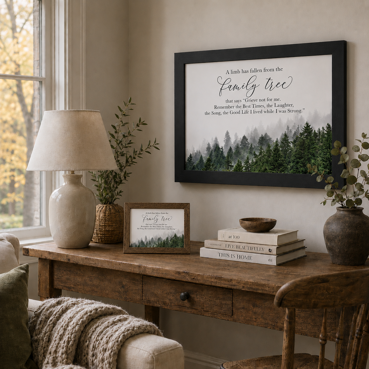 Farmhouse living room with A Limb Has Fallen From the Family Tree sympathy wall art SA23 — black 28x22 framed on the wall and natural brown 10x8 with easel back on the wooden desk beside a lamp and greenery
