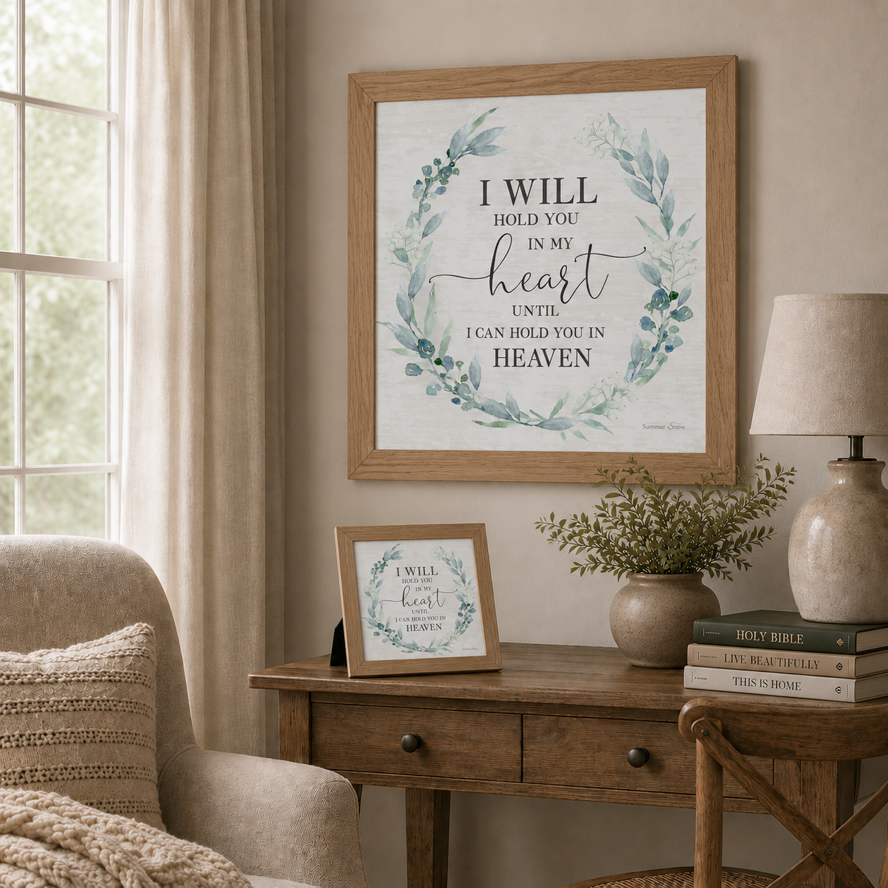 Soft neutral living room with I Will Hold You in My Heart Until I Can Hold You in Heaven wall art SS820 in farmtable frame — 20x20 hanging on wall and 8x8 easel back on wooden desk beside Holy Bible Live Beautifully and This Is Home books and greenery