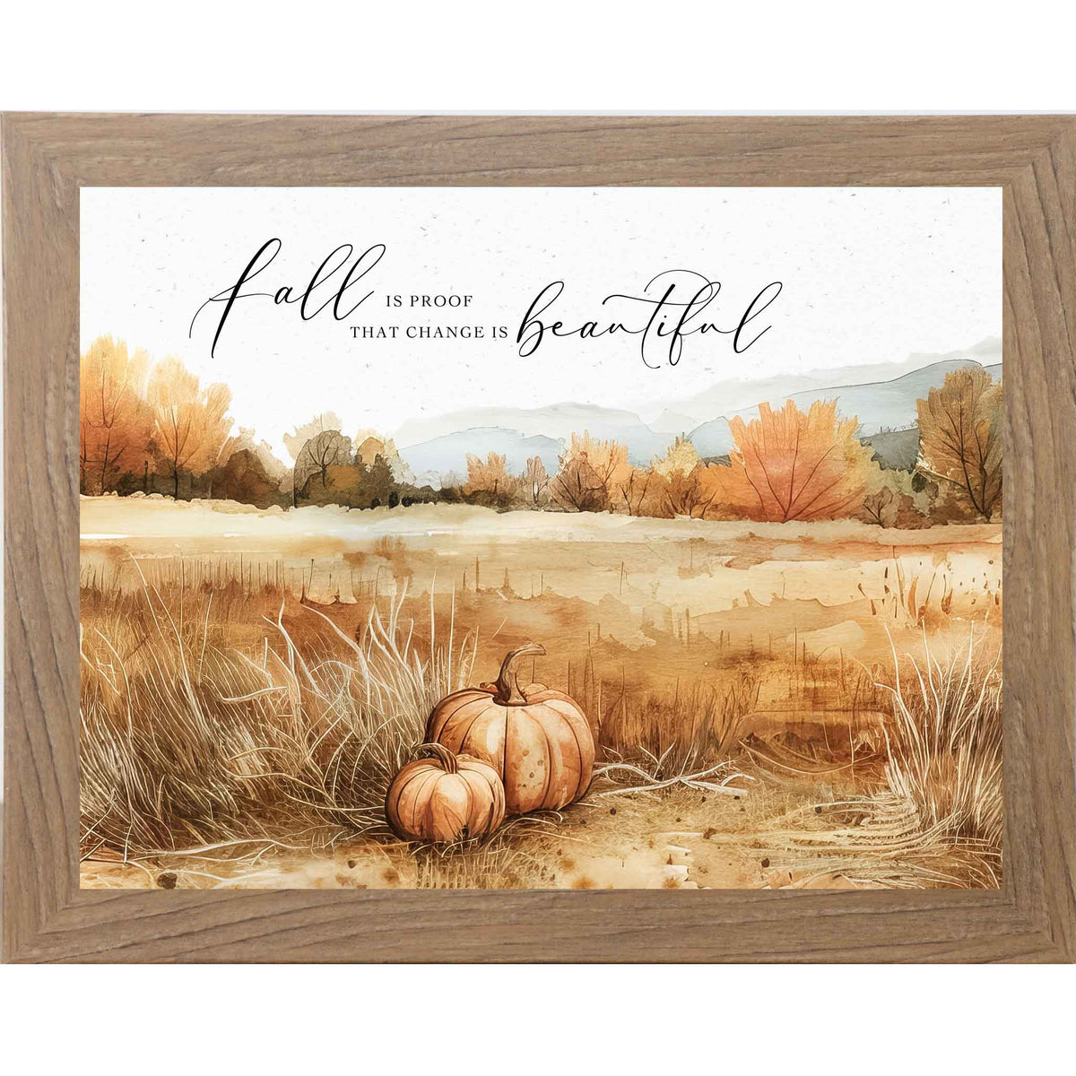Framed fall wall art with two pumpkins in a brown field, autumn trees, and the quote “Fall Is Proof That Change Is Beautiful”
