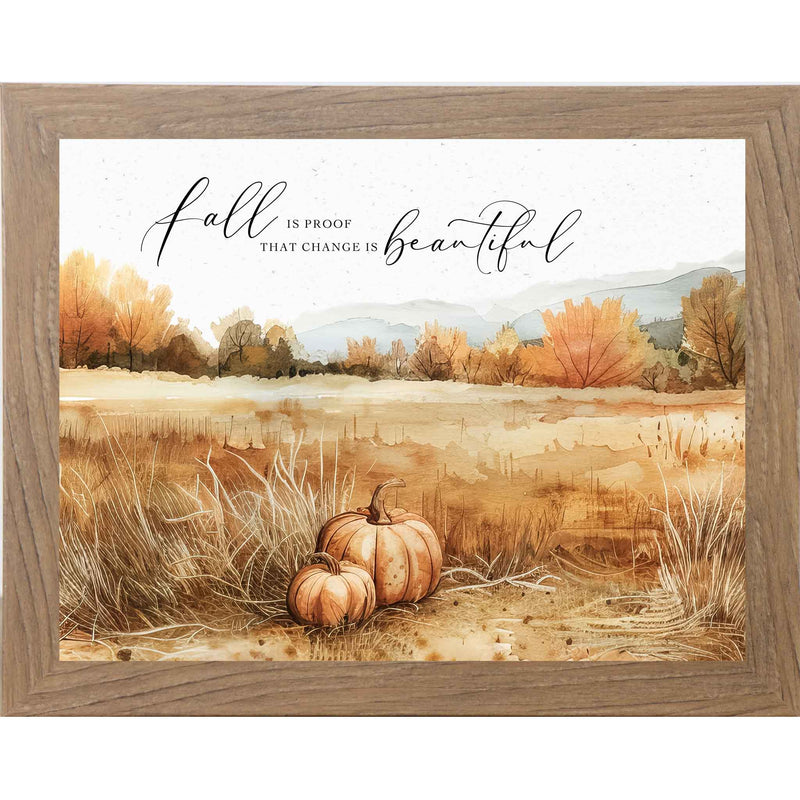 Framed fall wall art with two pumpkins in a brown field, autumn trees, and the quote “Fall Is Proof That Change Is Beautiful”