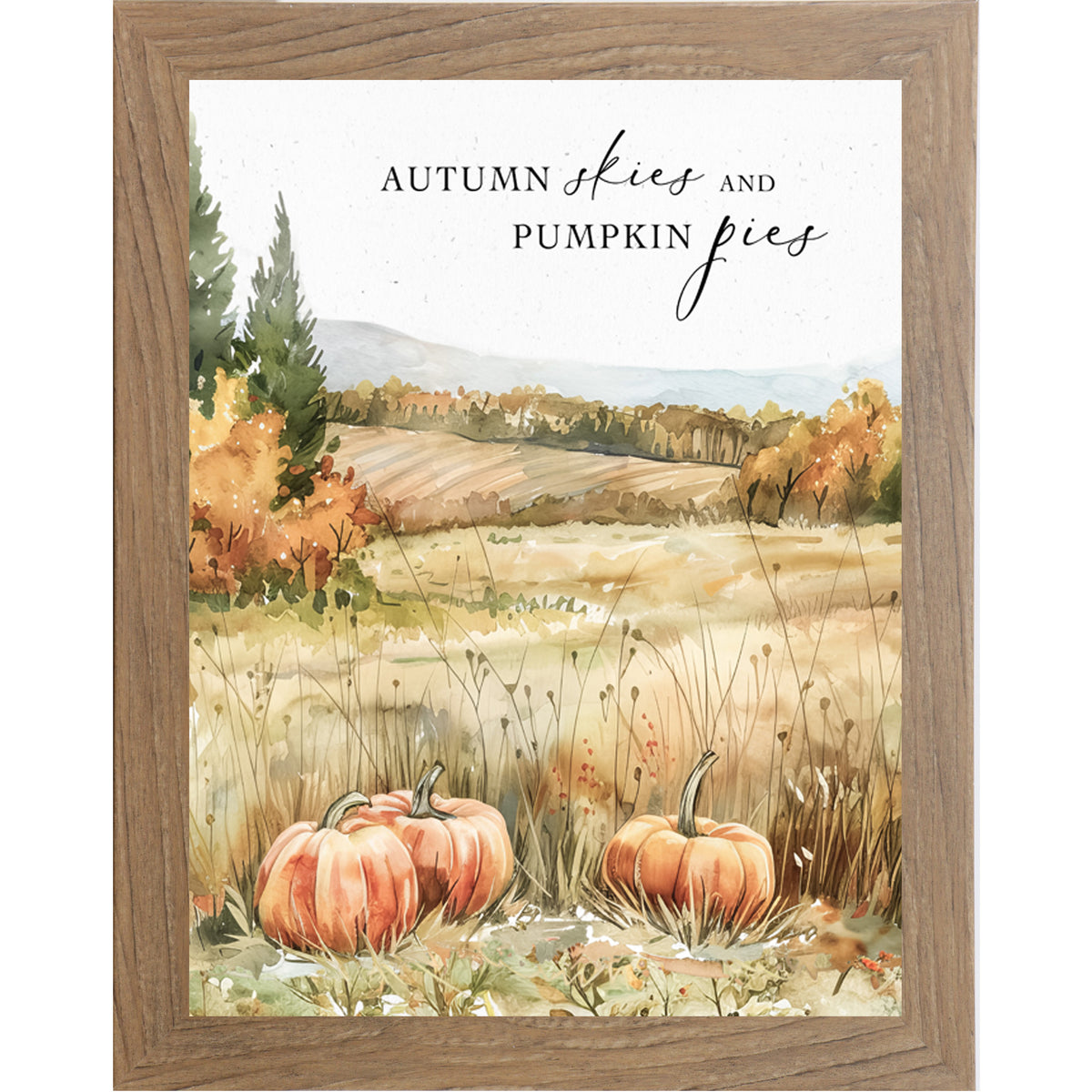Framed fall wall art with three pumpkins, tall grass, fall trees, and quote “Autumn Skies and Pumpkin Pies”