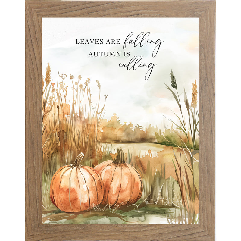 Framed fall wall art with pumpkins in tall grass, autumn trees, and quote “Leaves Are Falling, Autumn Is Calling”