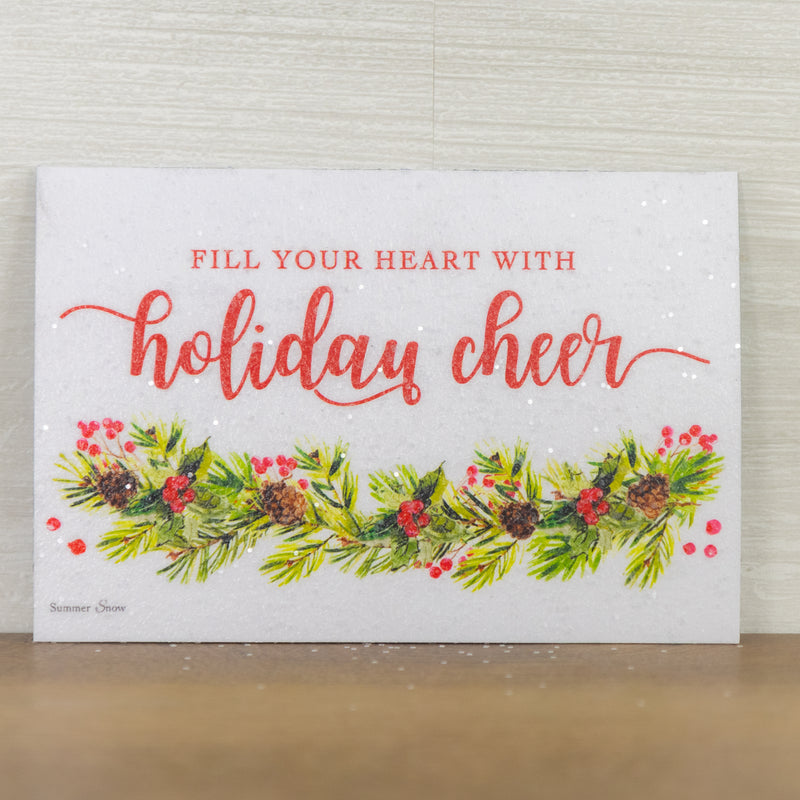 Fill Your Heart With Holiday Cheer magnet – 4x6 horizontal red text on white with pine, pinecones, and berries garland, glittered finish