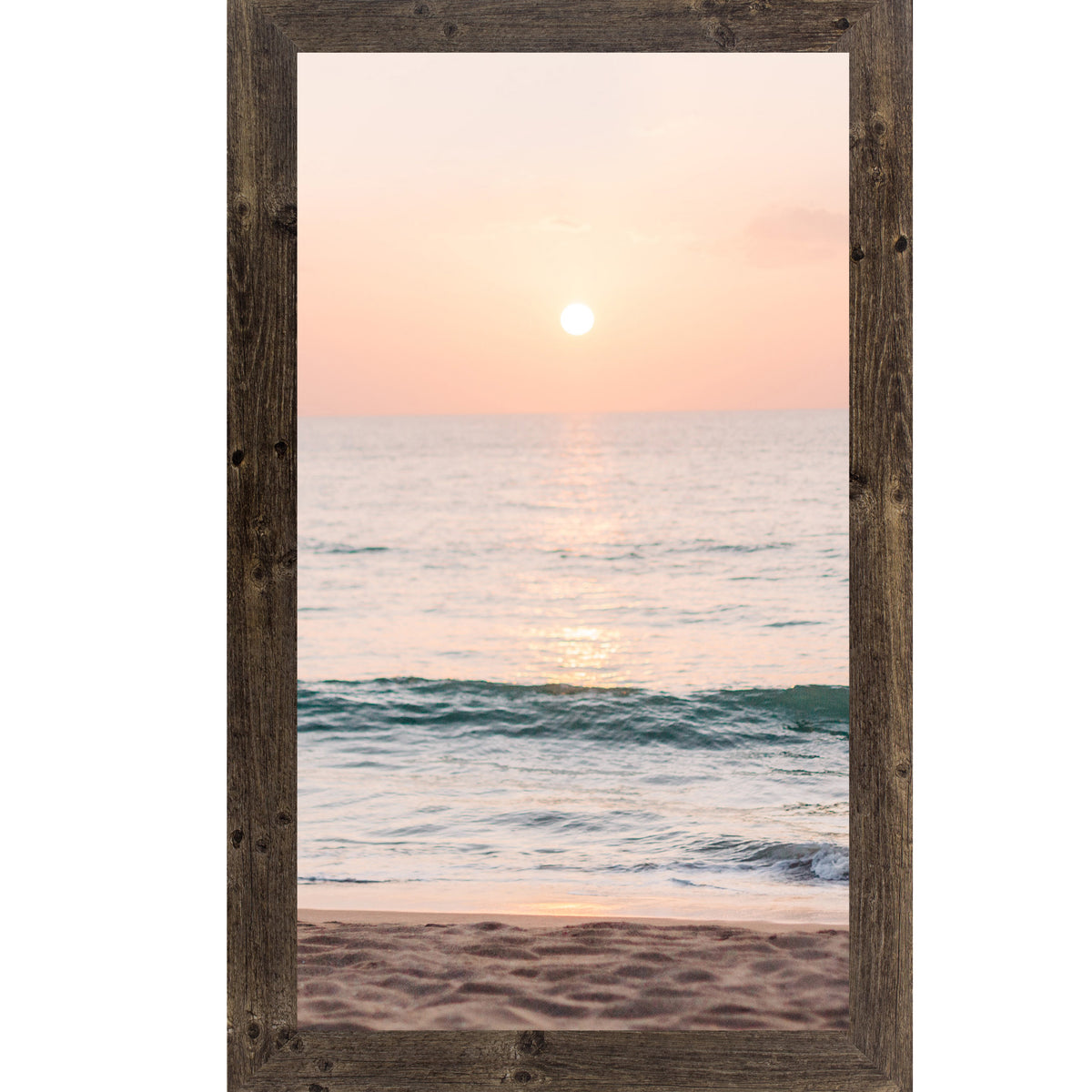 Natural brown framed tall portrait beach sunset wall art featuring a glowing sun above the horizon with soft peach and coral sky, shimmering teal ocean waves, and sandy shoreline