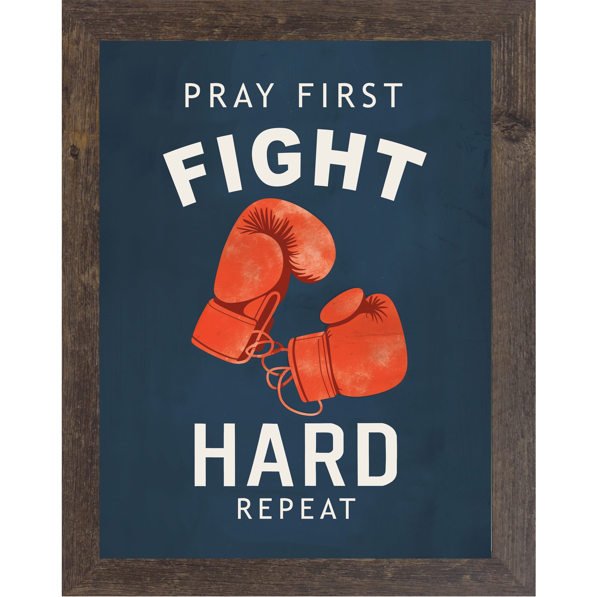 Natural Brown framed portrait Christian boxing wall art on navy blue background with bold cream varsity typography and vivid red boxing gloves with the words Pray First Fight Hard Repeat — SB262