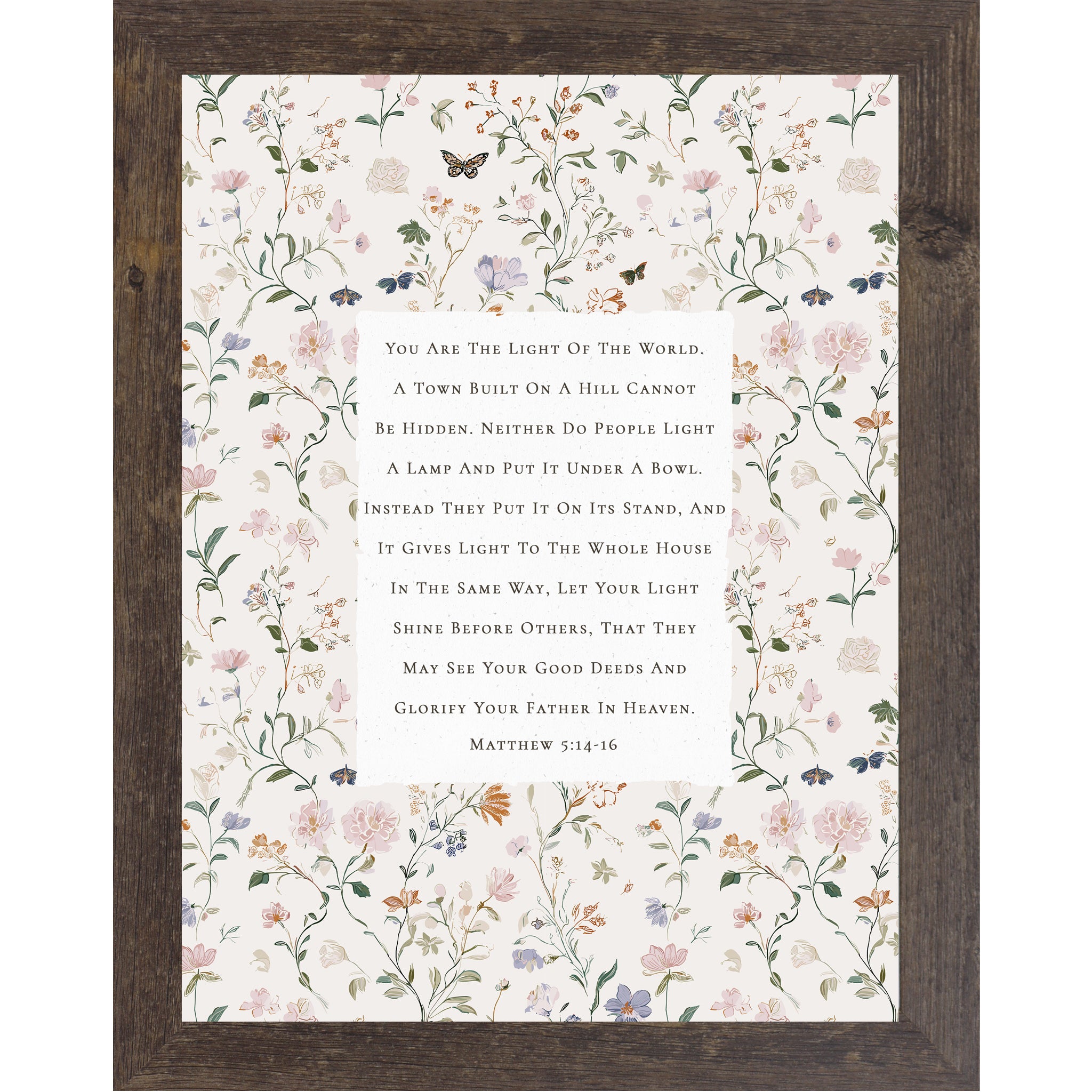 Vertical framed wall art featuring Matthew 5:14-16 Bible verse centered on a neutral background surrounded by soft pastel florals and butterflies, Christian scripture decor in 8x10 and larger sizes.