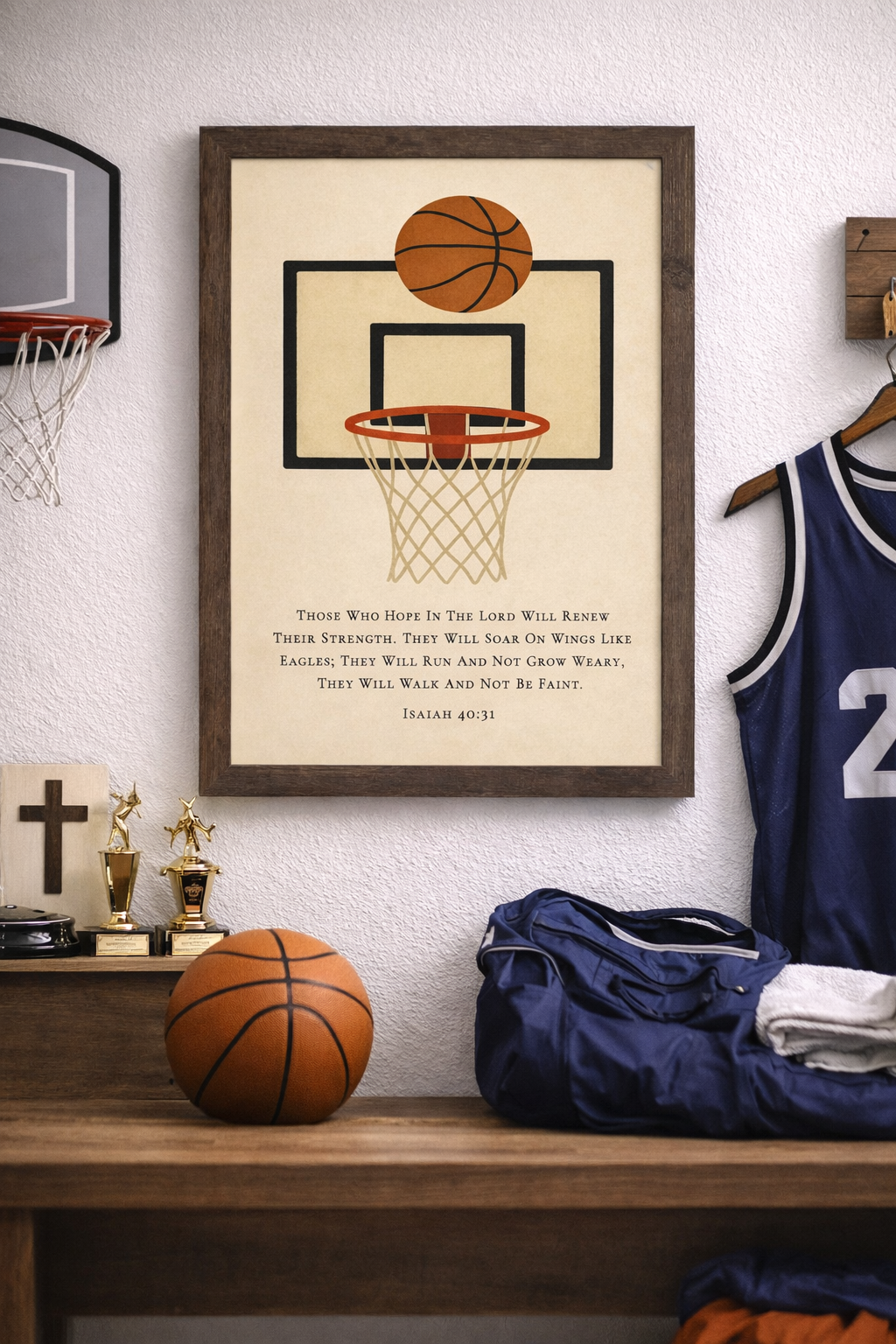 Room setting of a natural brown framed Christian basketball wall art featuring a basketball hoop illustration with the Bible verse Isaiah 40:31 on a neutral background.