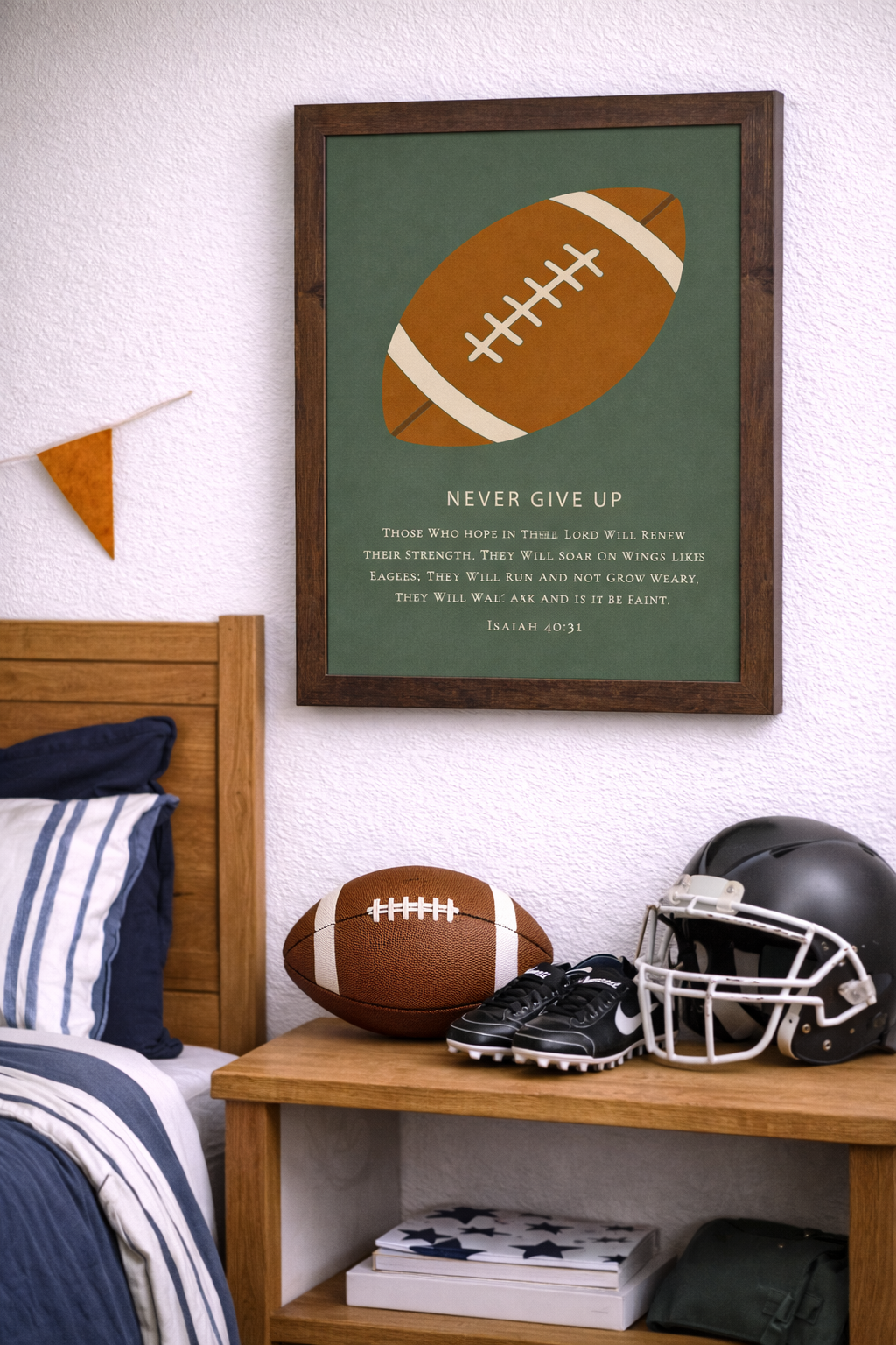 Room setting of a Natural brown color framed Christian football wall art featuring a football illustration with the phrase Never Give Up and Isaiah 40:31 scripture on a green background