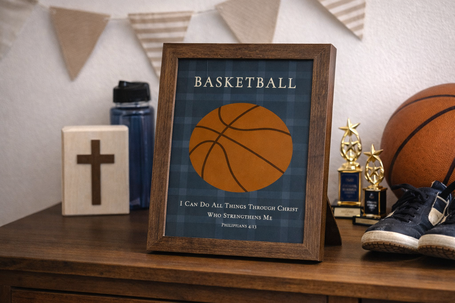 Room setting of a Christian basketball wall art featuring a basketball illustration with the Bible verse Philippians 4:13 on a blue plaid background. Featured in a Farmtable frame.