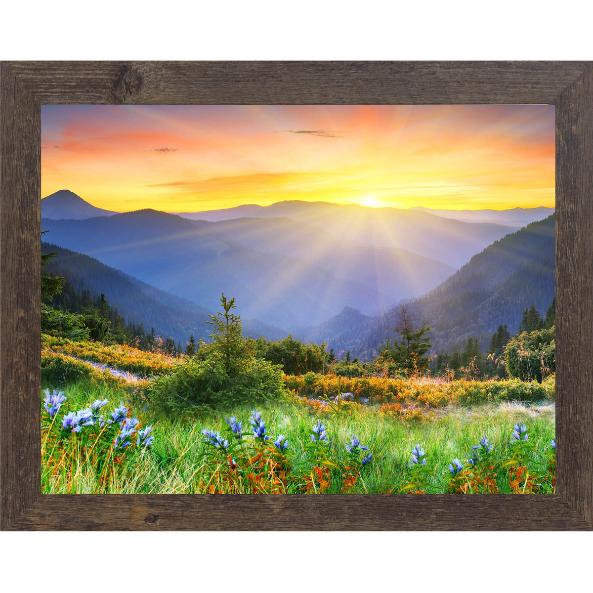 Framed landscape wall art with sunlit green hillside, colorful flowers, foggy forested mountains, and a golden sunrise in the background