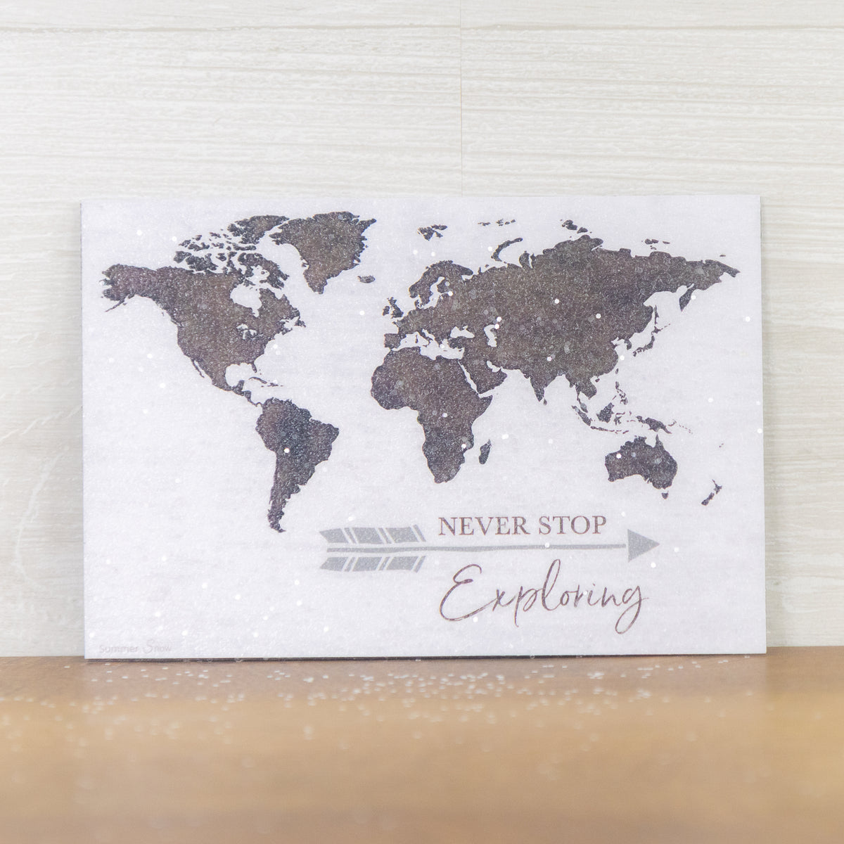 Never Stop Exploring magnet – 4x6 horizontal world map in brown on white with arrow and inspirational quote, glittered acrylic finish