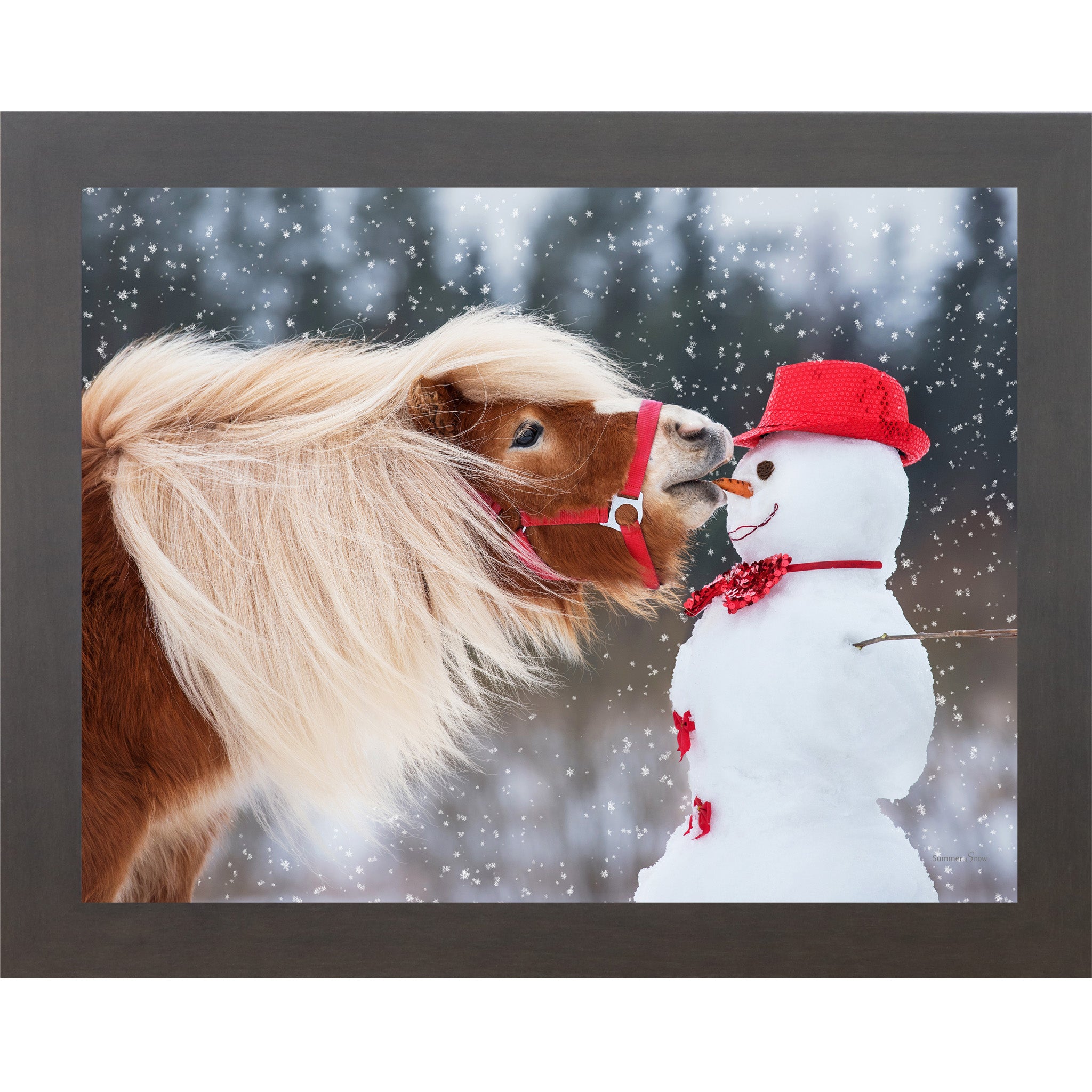 Slatewood framed landscape equine wall art featuring a chestnut Haflinger pony with flowing blonde mane stealing a carrot from a red-hatted snowman in falling snow — Can't Resist SN338