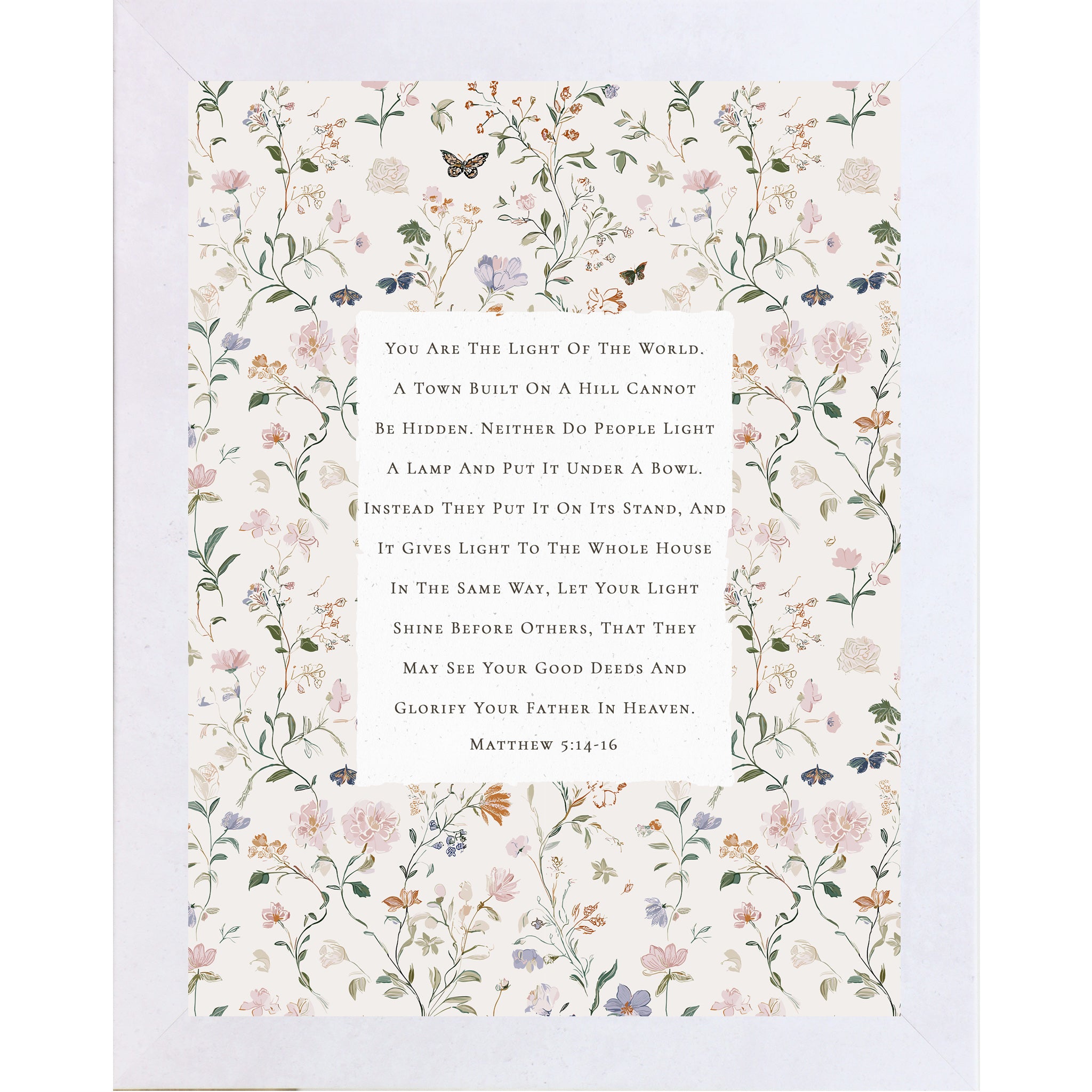 Vertical framed wall art featuring Matthew 5:14-16 Bible verse centered on a neutral background surrounded by soft pastel florals and butterflies, Christian scripture decor in 8x10 and larger sizes.