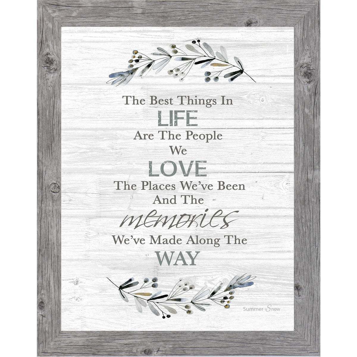 Vertical framed wall art featuring The Best Things in Life quote on gray slatted wood background with floral branches above and below, neutral inspirational home decor