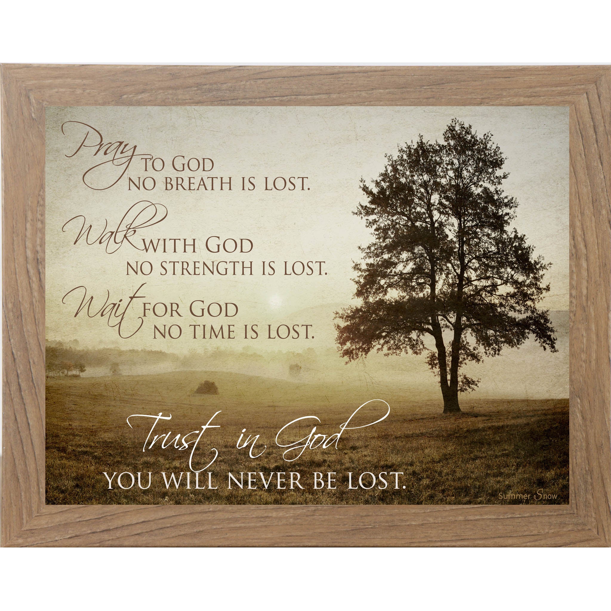 Framed Christian wall art with a misty morning field, golden sunrise, and inspirational faith quote about trusting in God, featuring a lone tree and soft haze.