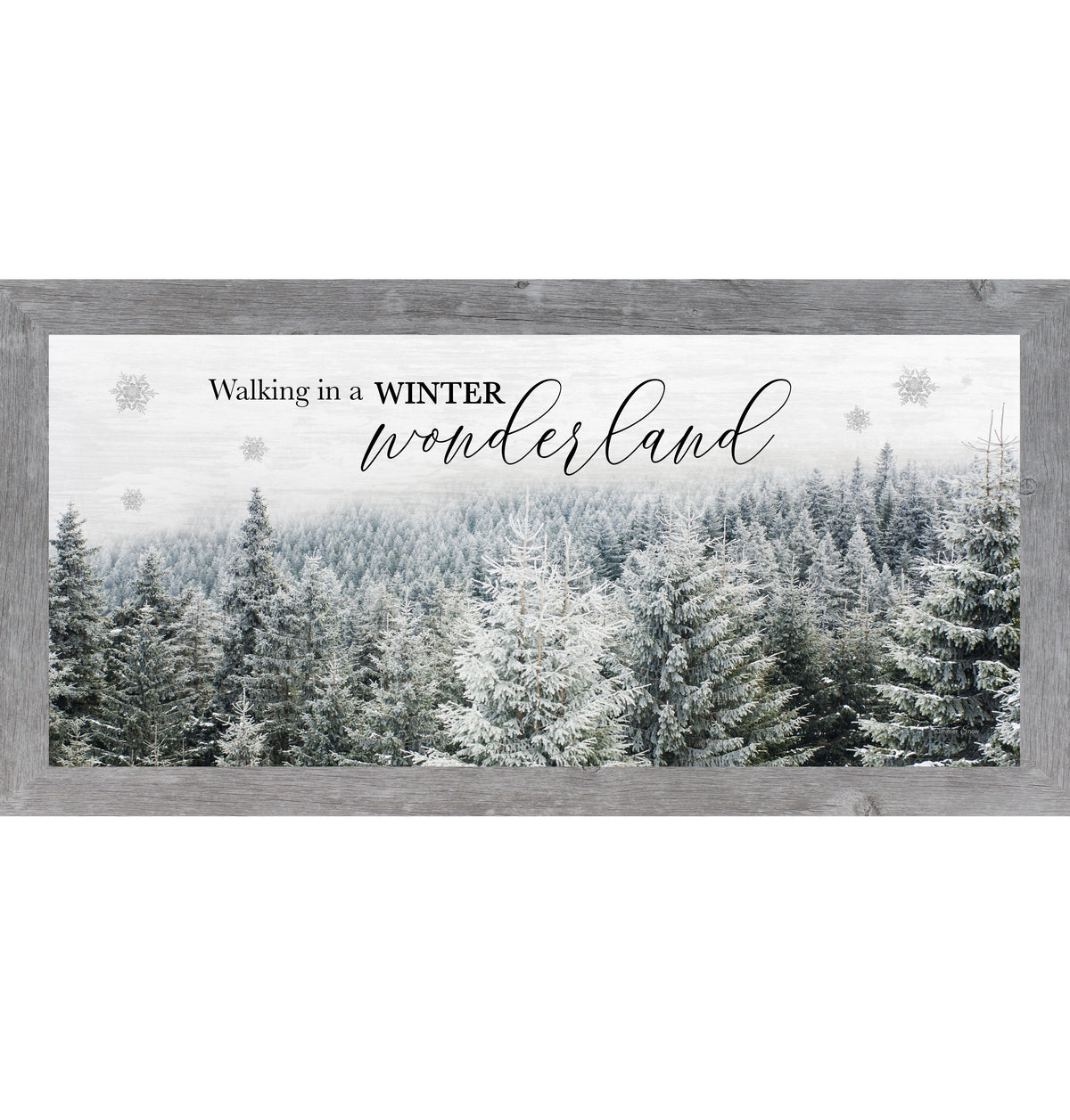 Framed winter wall art featuring a snowy evergreen forest with soft white faded sky and the words Walking in a Winter Wonderland