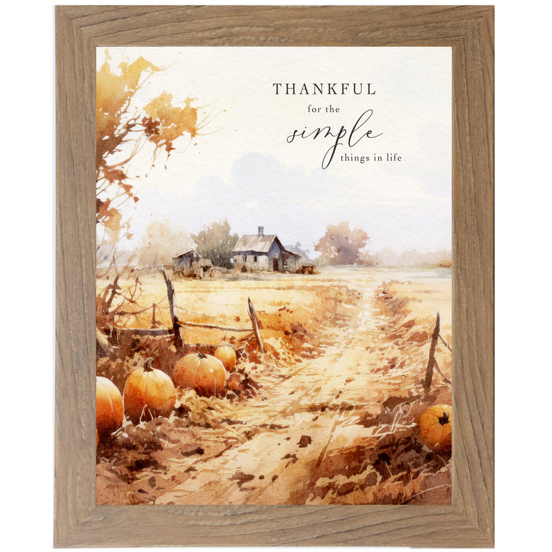Framed fall farmhouse art with pumpkins by a dirt road, brown grass, trees, and quote “Thankful for the simple things in life”
