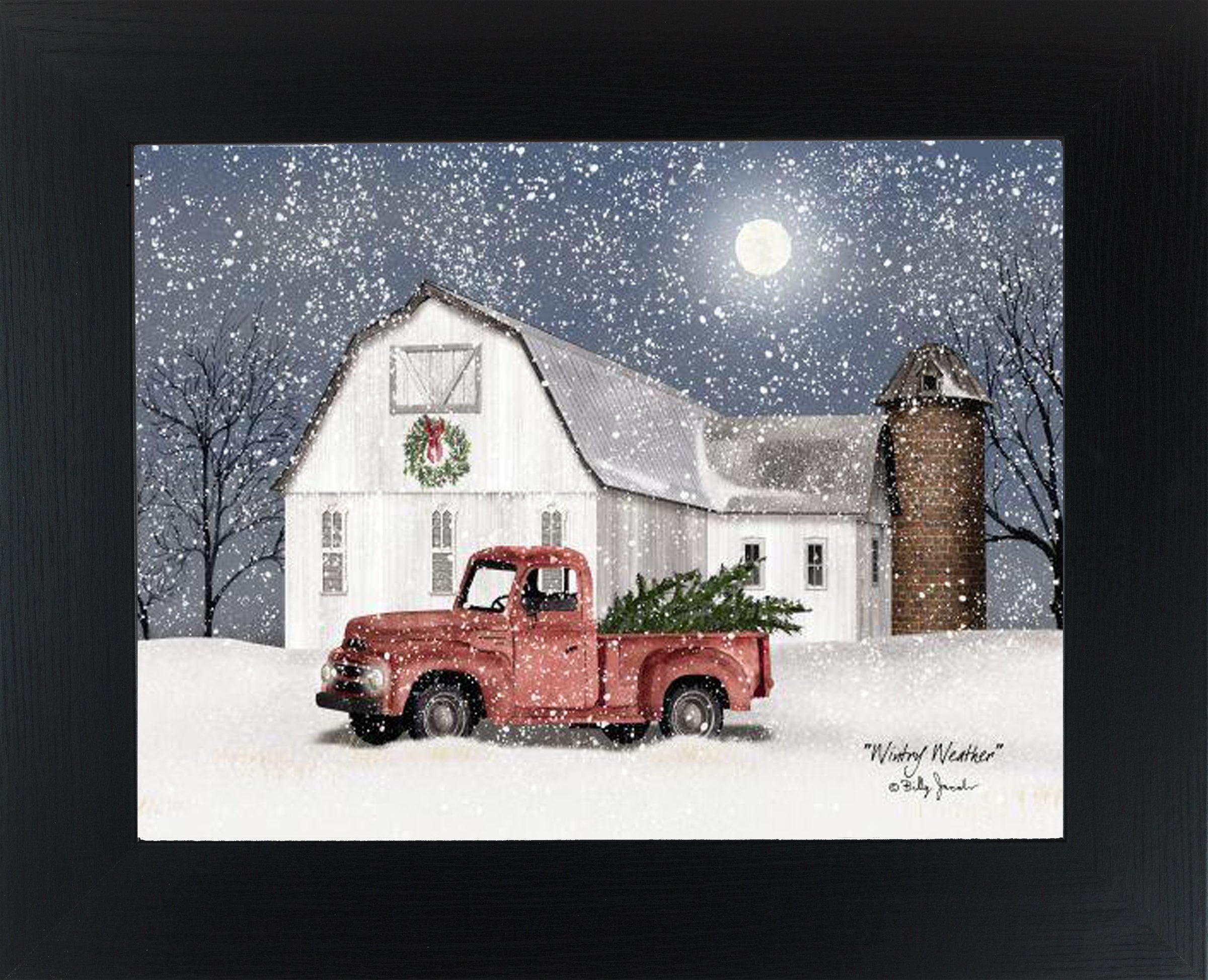 Winter farm framed wall art by Billy Jacobs featuring a white barn at night with falling snow and a red pickup truck carrying a green tree, Americana winter decor